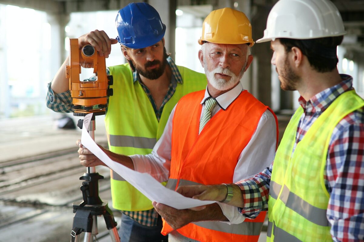 Team of construction engineers, architects working on building site