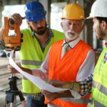 Team of construction engineers, architects working on building site