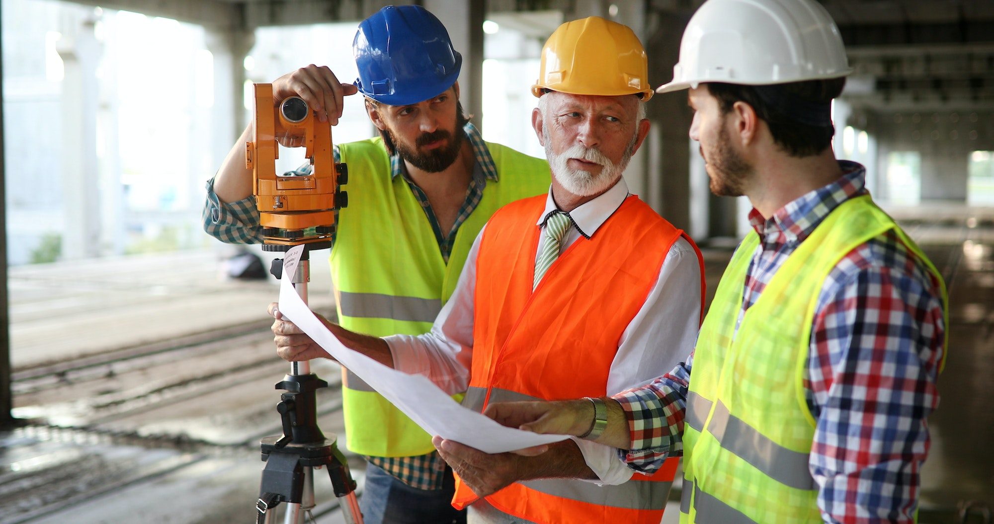 Team of construction engineers, architects working on building site